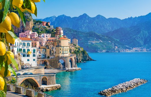 Lemons in the foreground with the Amalfi coast and mountains backdrop 