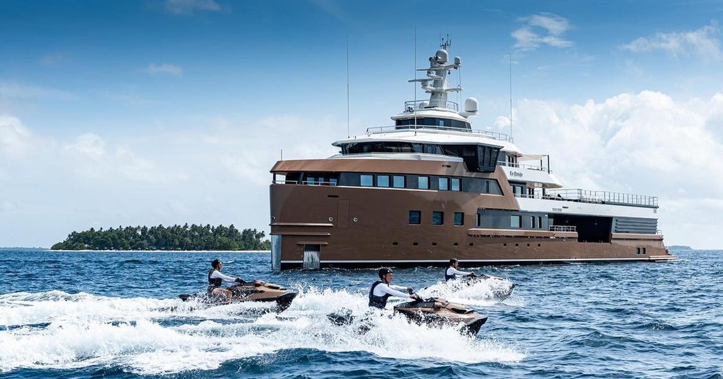 Charter yacht LA DATCHA at anchor with charter guests on Jet Skis