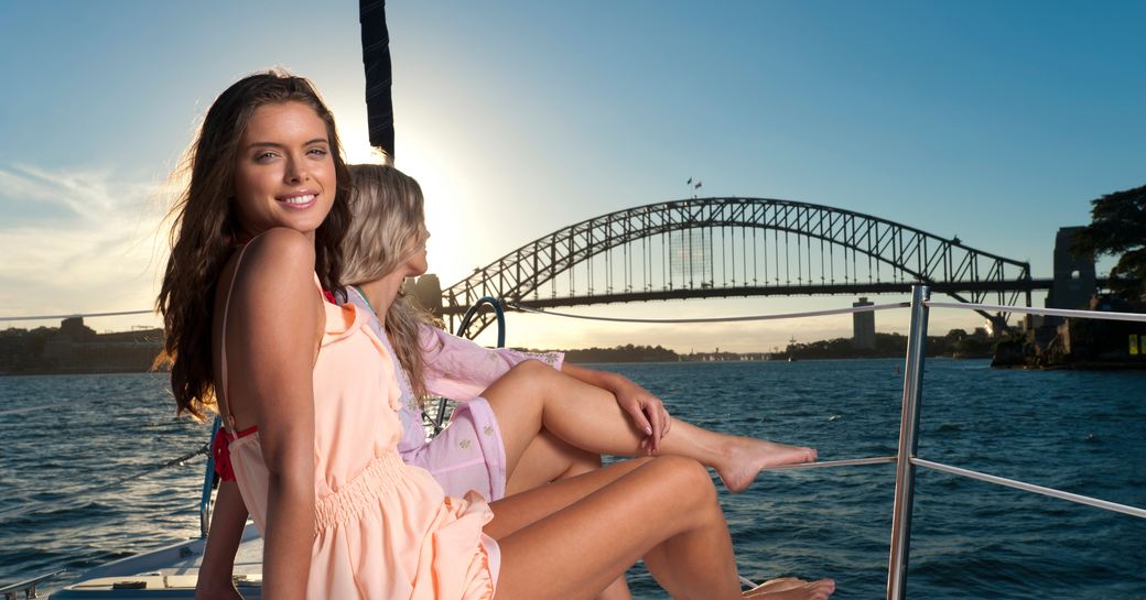 Girl on a yacht looking at the camera on a sailing yacht in Sydney Harbor, Australia