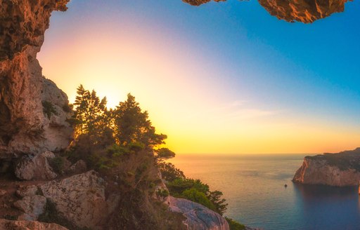 Sardinia's beautiful red rocky coves at sunset